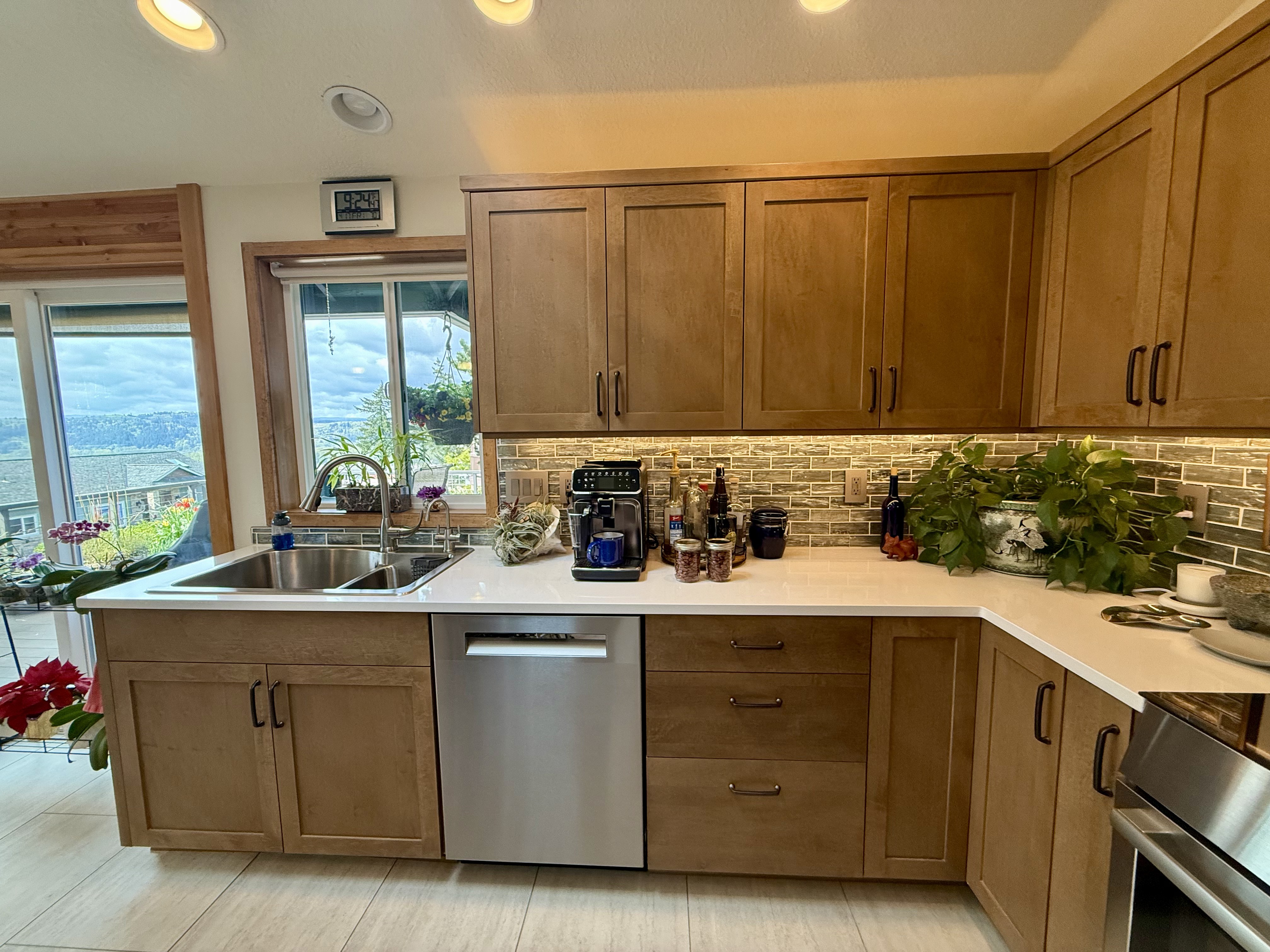 Maple slab cabinet doors with routed finger pulls and quartz countertop