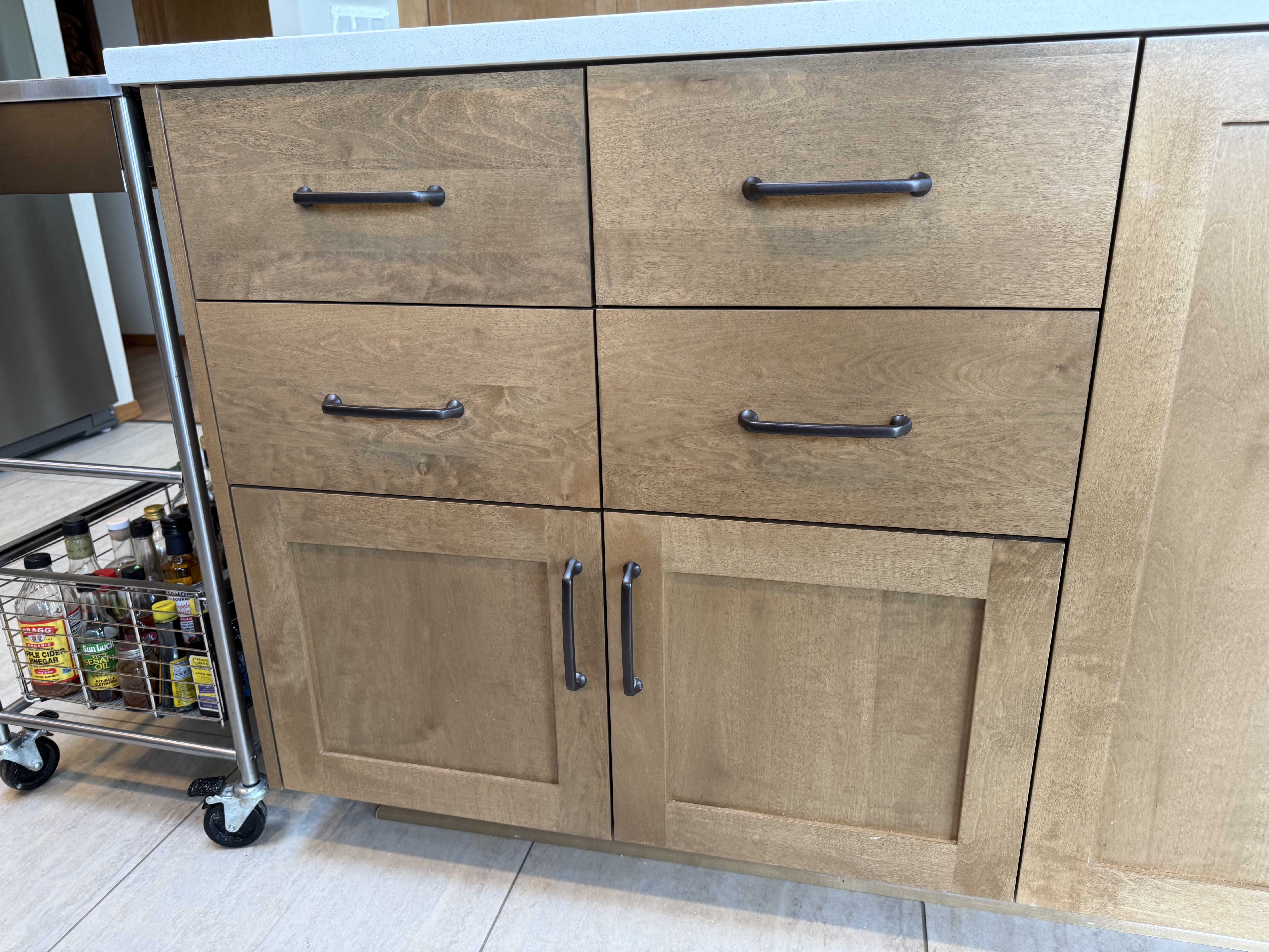 Full-height maple slab pantry doors in contemporary open-plan kitchen