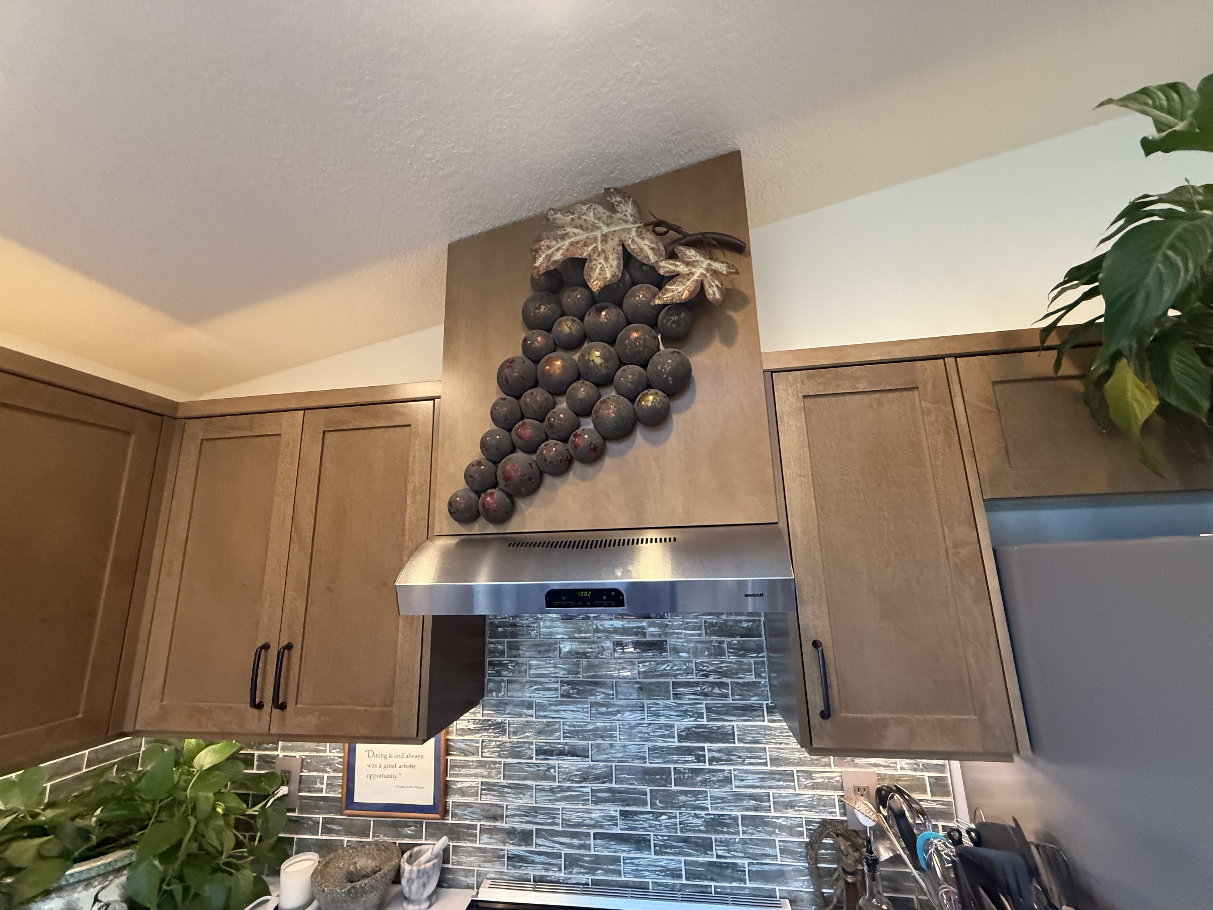 Seamless maple slab cabinetry run with concealed appliance garage