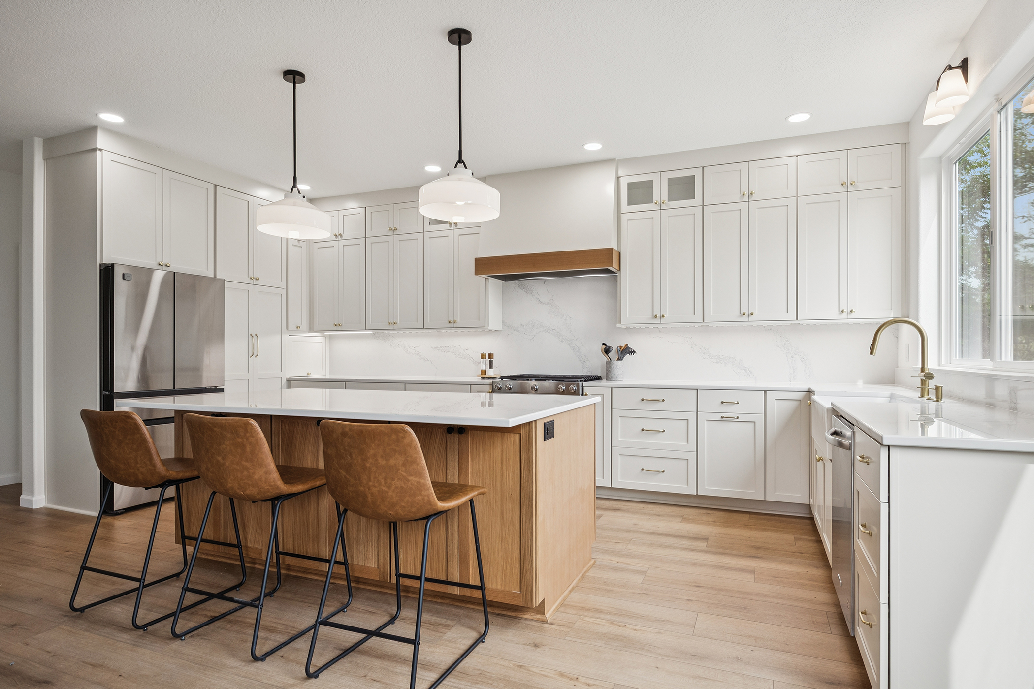 Custom pantry organization with pullout shelves in painted shaker cabinetry